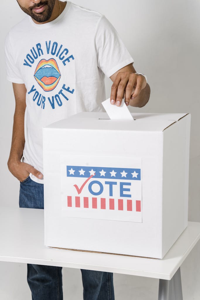 A Man Putting a Ballot on a Box